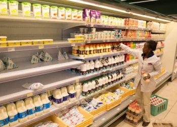 An employee restocks the dairy products section at a supermarket in Nairobi, Kenya May 8, 2017.