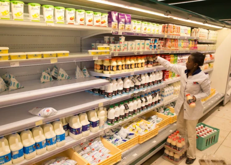 An employee restocks the dairy products section at a supermarket in Nairobi, Kenya May 8, 2017.