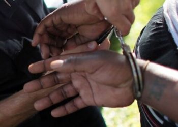 Police placing a suspect in handcuffs during an arrest Photo NPS