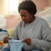 An AI-generated image depicts a woman holding an infant's cloth.
