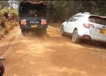 Police take away the body of a man that was discovered in the bush in Kutus.
