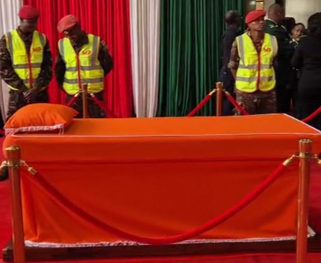 An orange-draped bed, which had been prepared in Parliament
