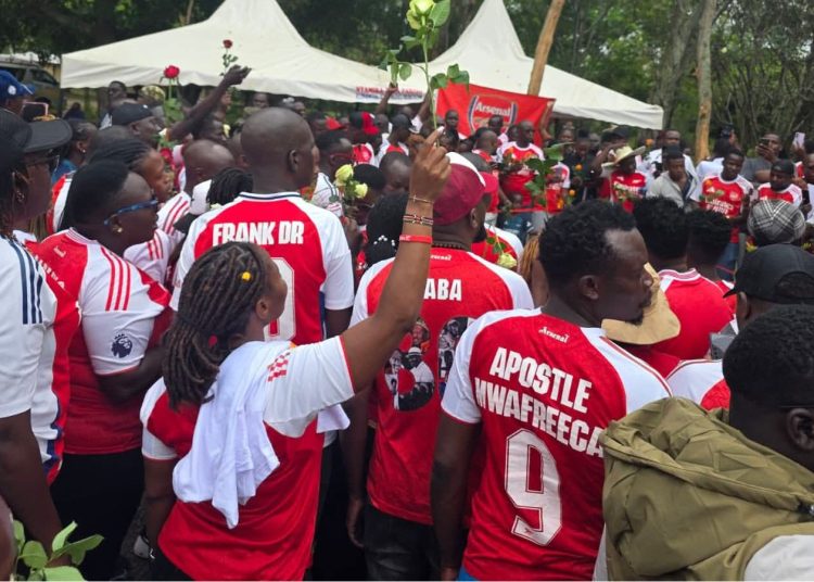 File image of Arsenal fans at Raila Odinga's gravesite in Bondo