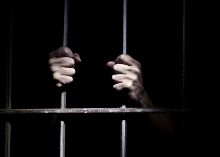 A person in a prison cell.