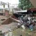 Stacked school desks at a damaged school after torrential rains that overflowed rivers, causing flooding