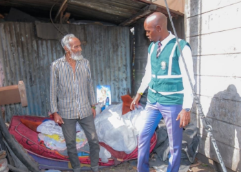 Nairobi City County Chief Environment Officer Geoffrey Mosiria with the homeless man on October 8, 2025.