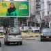 Motorists drive past an electoral campaign billboard of Tanzania's President Samia Suluhu Hassan of the ruling Chama Cha Mapinduzi Party (CCM) ahead of the general elections in Ilala district of Dar es Salaam, Tanzania October 28, 2025.
