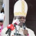 KCCB chairman Archbishop Maurice Muhatia Makumba unveils the bottle of the new wine