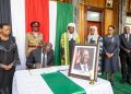 President William Ruto signing a condolence book at Parliament.