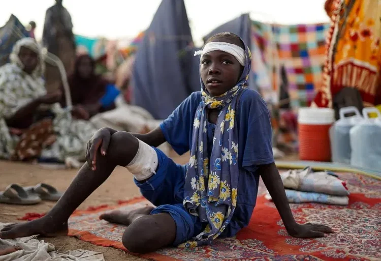 A boy sits at a camp for displaced people who fled from el-Fasher to Tawila, North Darfur, on October 27, 2025