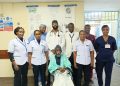 Ibrahim Mungai, who had been immobile for 20 years, with KNH doctors after a successful medical intervention
