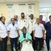 Ibrahim Mungai, who had been immobile for 20 years, with KNH doctors after a successful medical intervention