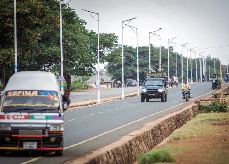 Tanzanian Police officers patrol in the streets as supporters of ACT-Wazalendo party protest in Kigoma on October 30, 2025 a day after Tanzania's presidential and legislative elections.