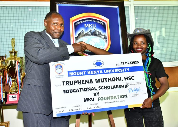 Truphena Muthoni being awarded full academic scholarship by Professor Peter Wanderi