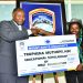Truphena Muthoni being awarded full academic scholarship by Professor Peter Wanderi