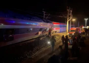 Emergency responders work at the site after a high-speed train derailed and smashed into another oncoming train, near Adamuz, in Cordoba, Spain, on January 18, 2026