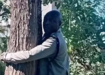 A photo of OCS Kennedy Wanjala attenpting the Tree- Hugging Challenge on Tuesday, January 20