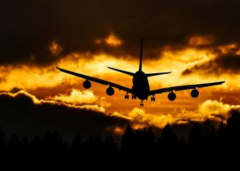 Airplane silhouette on air during sunset